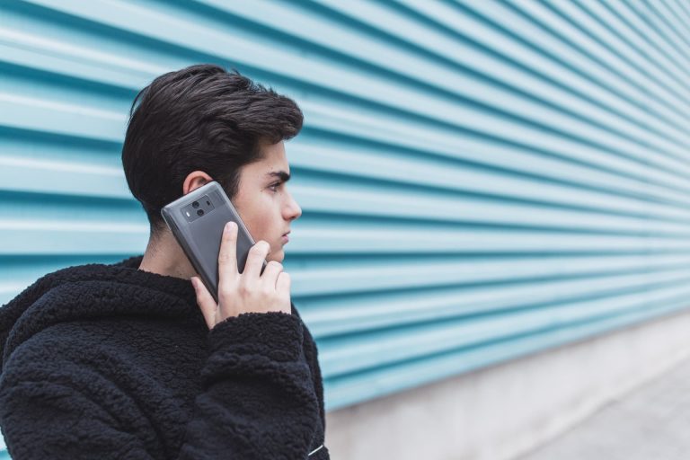 young-man-talking-on-smartphone-2022-03-04-05-44-59-utc